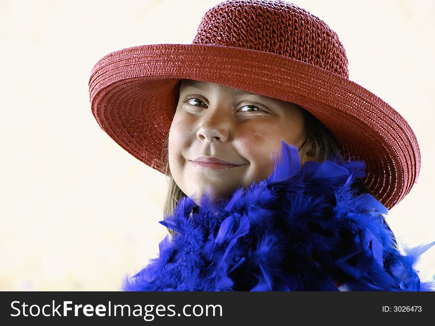 Beautiful smiling young lady wearing red hat and purple boa. Beautiful smiling young lady wearing red hat and purple boa