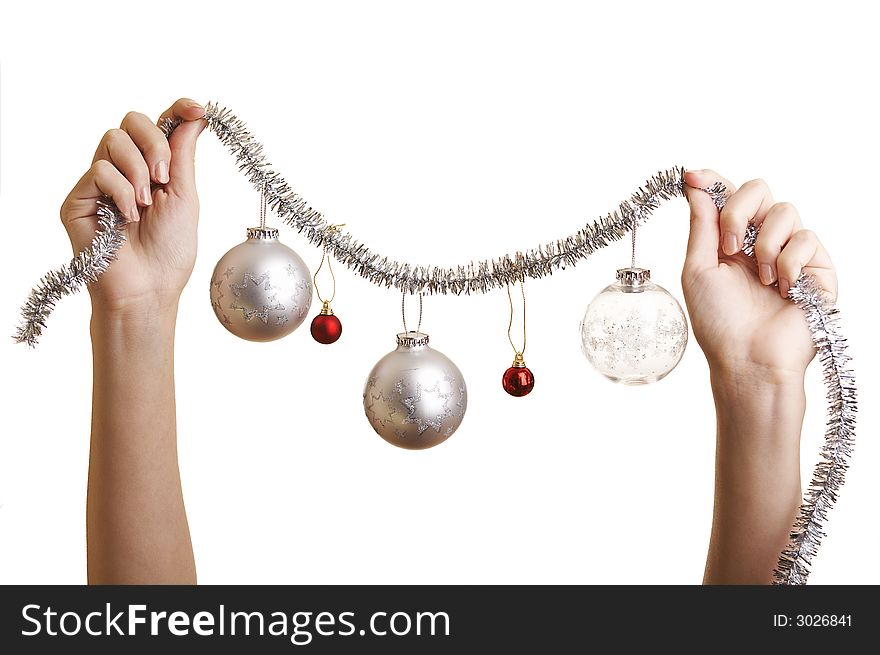 Woman about to hang a Christmas ornaments