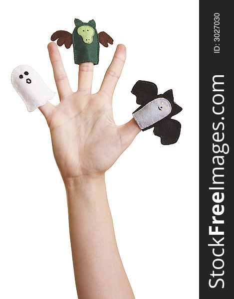 Girl's hand with halloween finger puppets (ghost, bat and dragon)