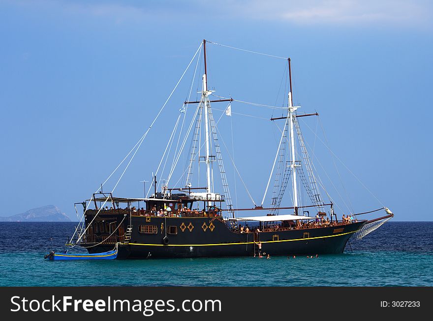 Old sailboat with tourists in the blue