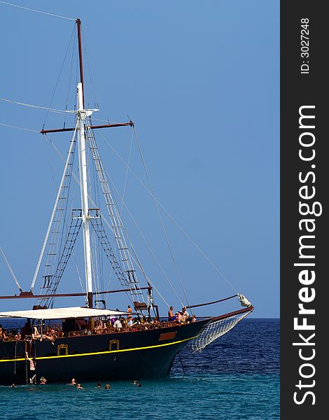 Old sailboat with tourists in the blue