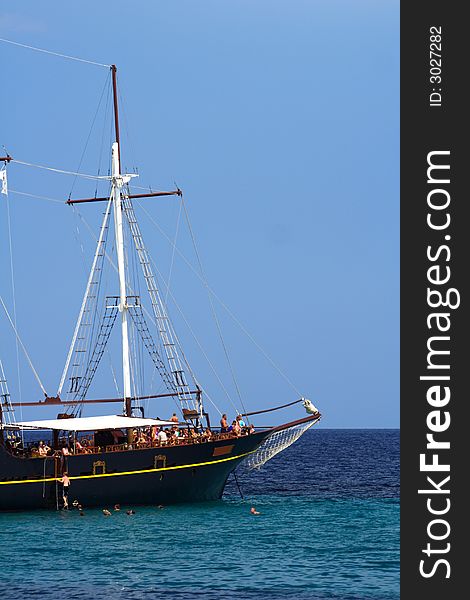 Old sailboat with tourists in the blue