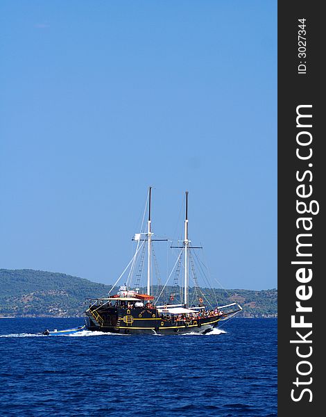 Old sailboat with tourists in the blue