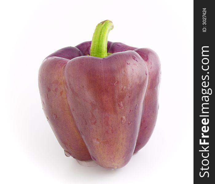 Fresh violet pepper bell with drops of water