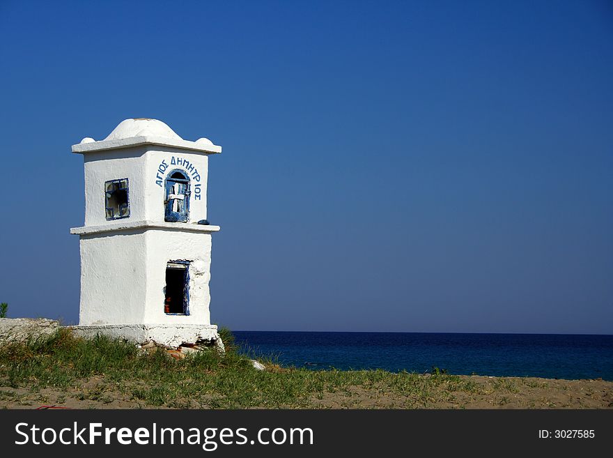 White shrine on the coast in Greece. White shrine on the coast in Greece