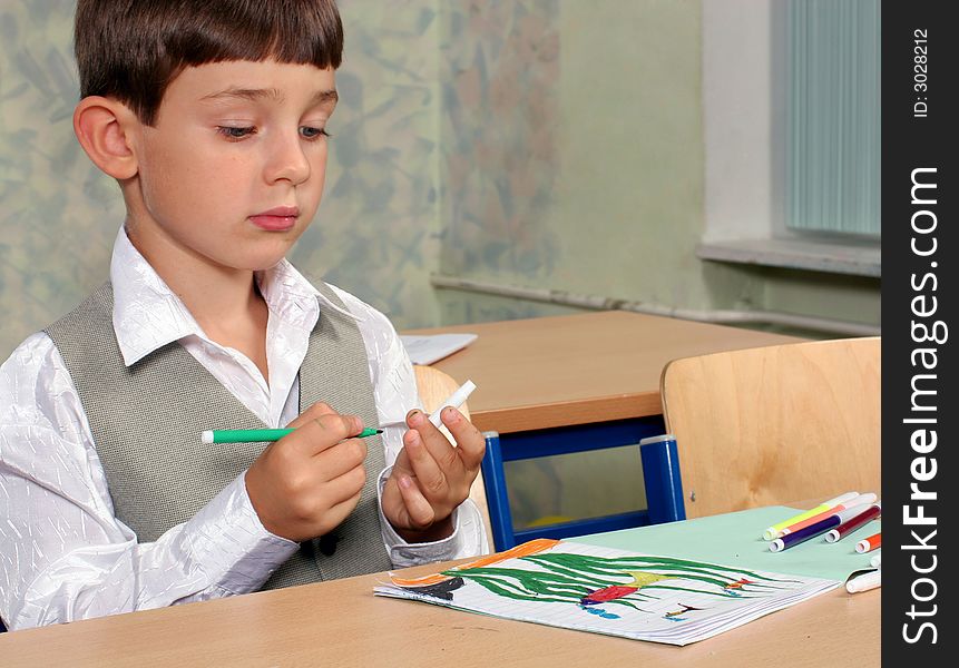 Portrait of the schoolboy with his picture. Portrait of the schoolboy with his picture