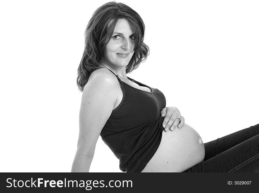 Beautiful woman smiling and holding her belly. Beautiful woman smiling and holding her belly.