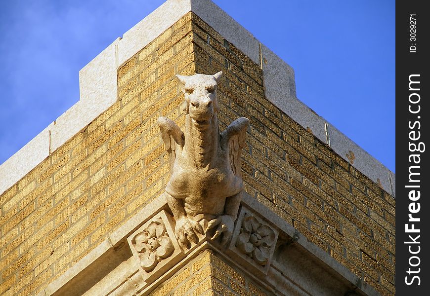 Gargoyle appears to be growing out of the corner of this old church. Gargoyle appears to be growing out of the corner of this old church