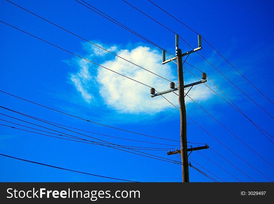 A telegraph pole on a sunny blue sky day