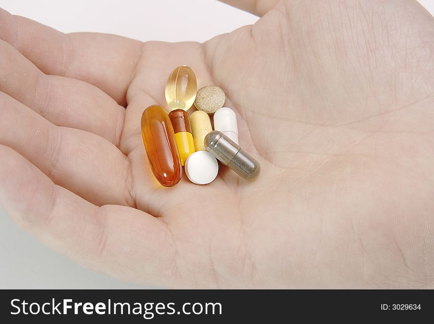 Male hand full of pills, vitamins and medicine. Male hand full of pills, vitamins and medicine