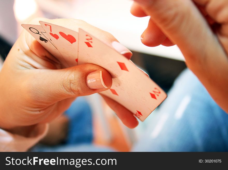 Woman hand holding three playing cards. Woman hand holding three playing cards