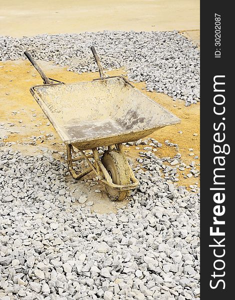 Image of Old wheelbarrow at construction site