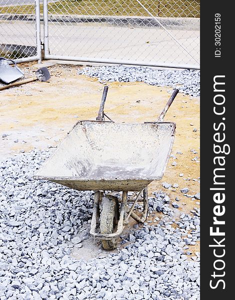 Image of Old wheelbarrow at construction site