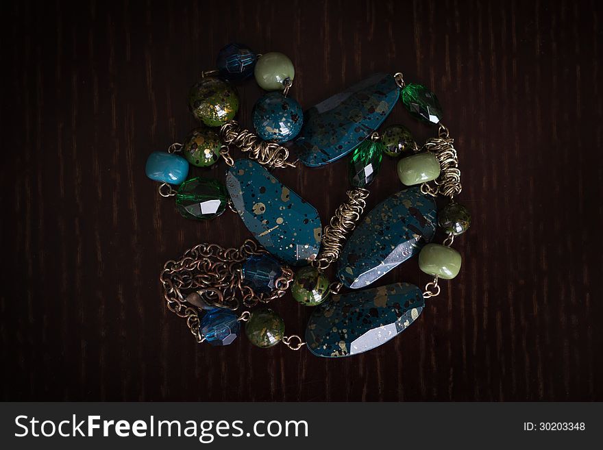 Elegant ornament from a multi-colored beads against a dark background