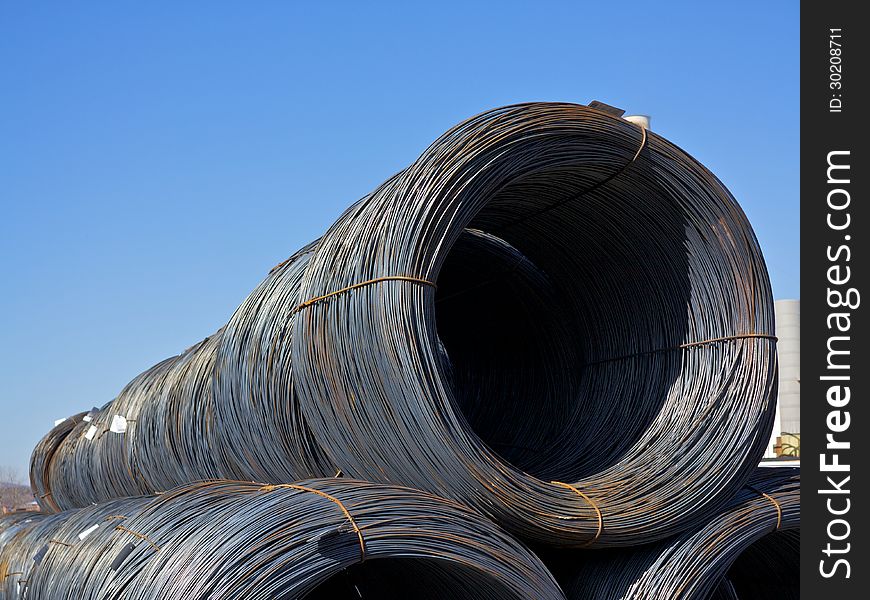 Top of a Stacked row of newly manufactured steel wire coils. Top of a Stacked row of newly manufactured steel wire coils.