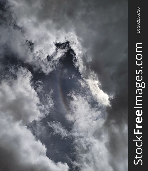 Rainbow And Circle Of Cloudy Clouds