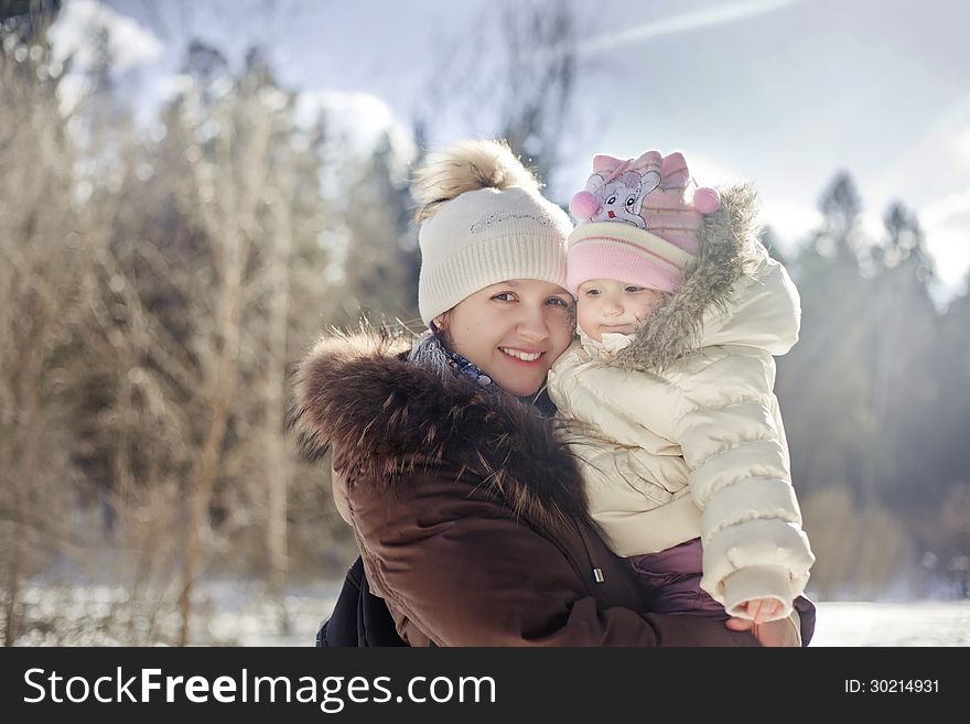 Winter outdoor portrait of mother and baby. Winter outdoor portrait of mother and baby