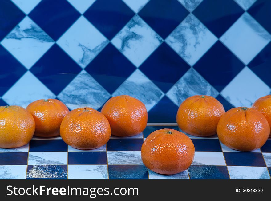 Playing draught with orange mandarines. Playing draught with orange mandarines