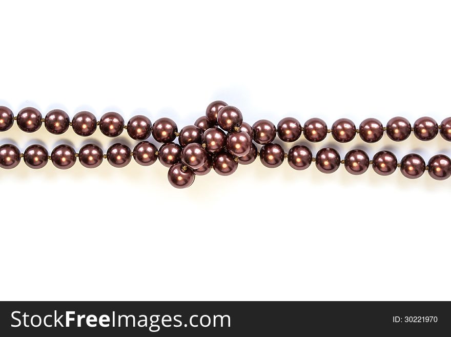 Knotted thread of purple bead isolated over white. Knotted thread of purple bead isolated over white