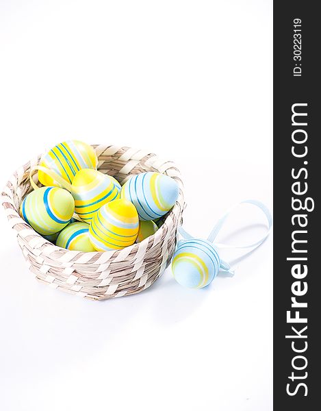 Easter eggs in basket isolated on white