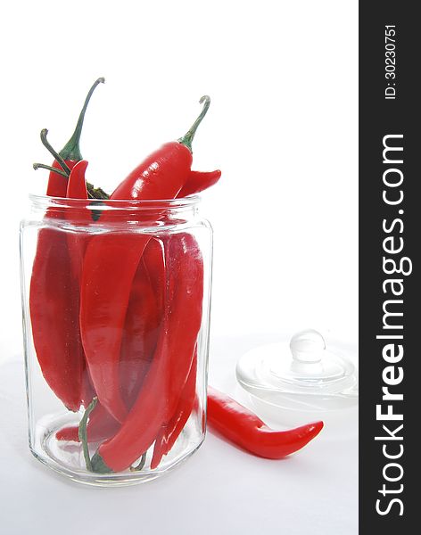 Some red chillies in a glass jar. Some red chillies in a glass jar.