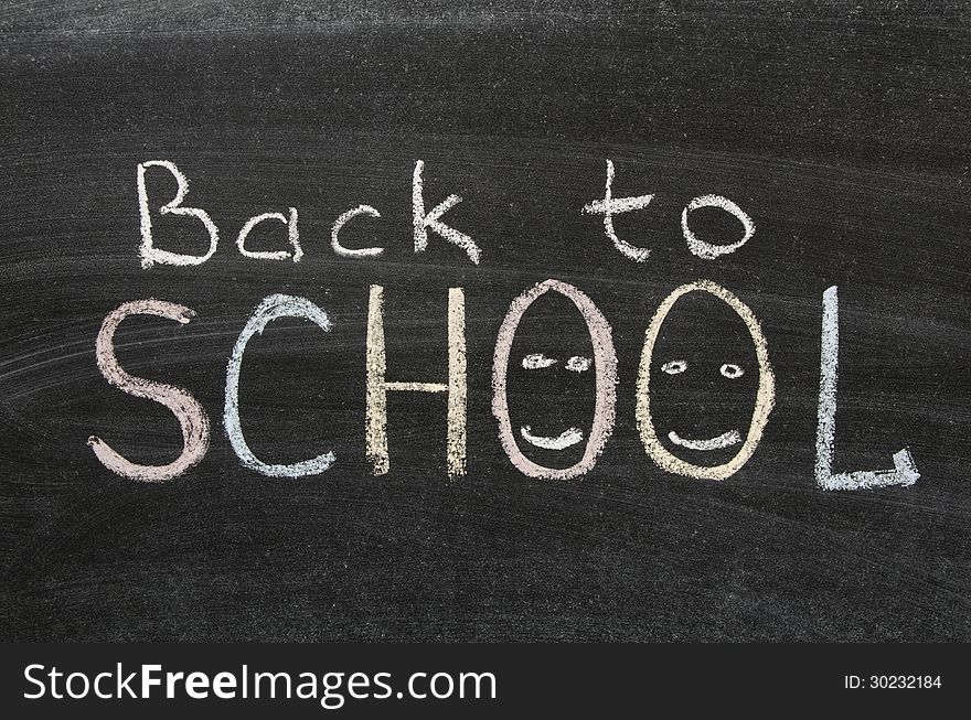 Back to school phrase handwritten on blackboard