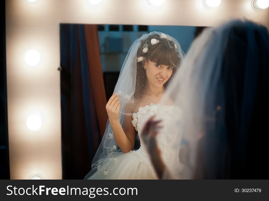 Photo portrait of a pretty girl bride in mirror image. Photo portrait of a pretty girl bride in mirror image