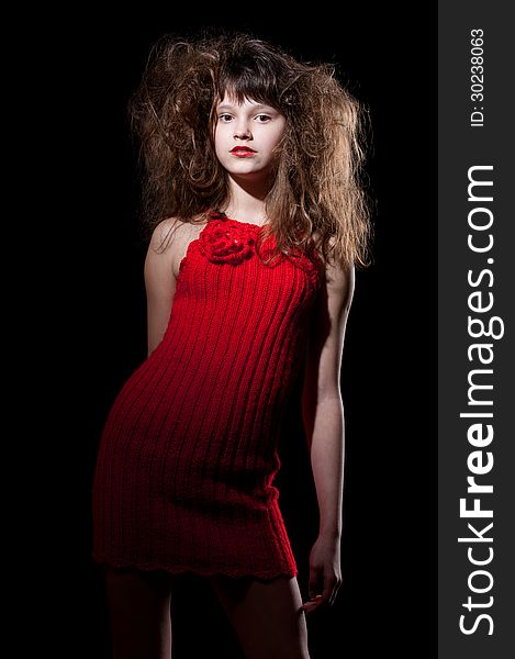 Young girl in a red dress on black, isolated. Young girl in a red dress on black, isolated