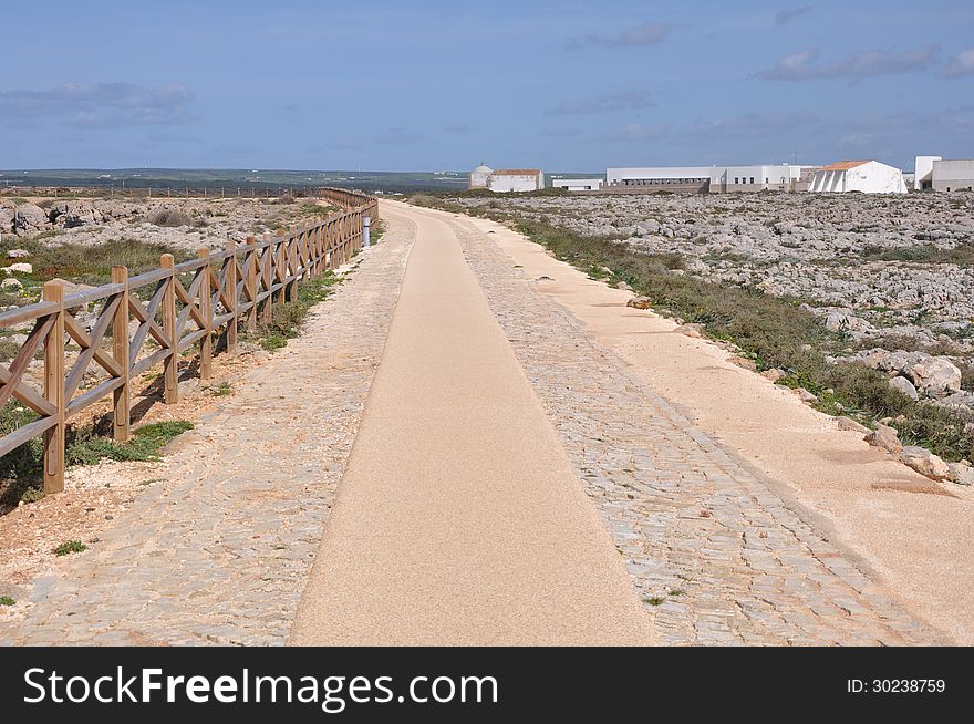 Image shows coast of Sagres with hiking trail and wooden balustrade, Algarve, Portugal, Europe. Image shows coast of Sagres with hiking trail and wooden balustrade, Algarve, Portugal, Europe.