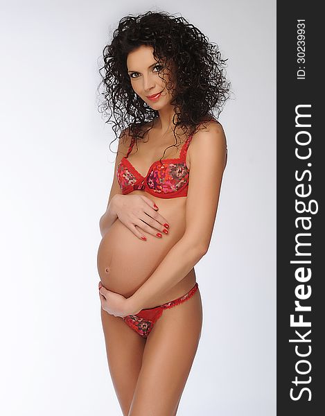 Beautiful pregnant woman - over a white background