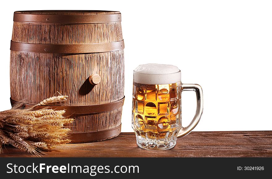 Beer glasses with a wooden barrel on a white background. File contains a clipping path. Beer glasses with a wooden barrel on a white background. File contains a clipping path.