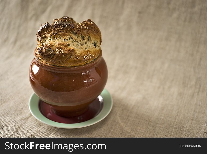 Bread covering of a casserole with fennel and sesame on the top