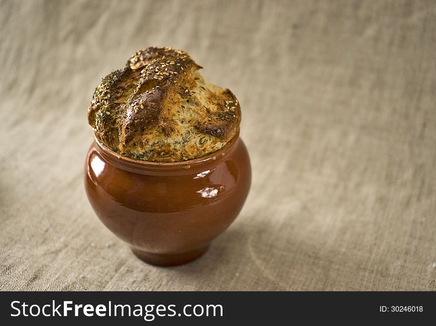 Bread covering of a casserole with fennel and sesame on the top