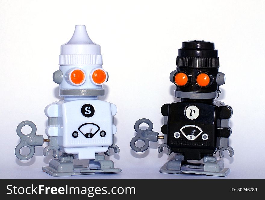 Salt and pepper shakers in the form of robots o white background. Salt and pepper shakers in the form of robots o white background