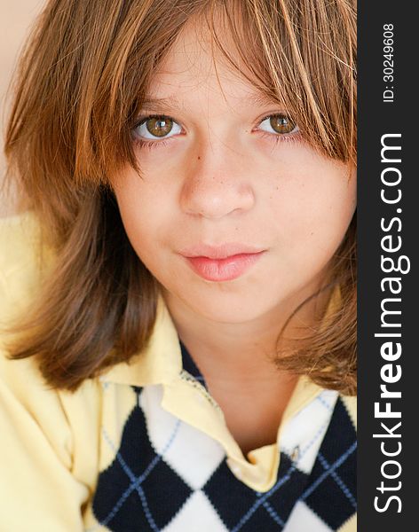 Close-up of a boy with neutral expression looking at camera