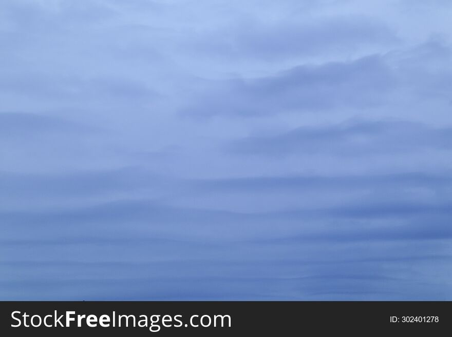 Background of lines of gray clouds in cloudy weather early in the morning