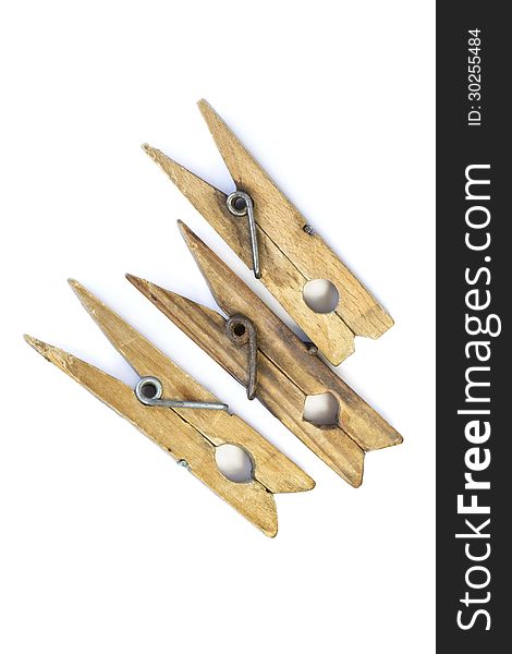 Three old wooden clothespin isolated over white