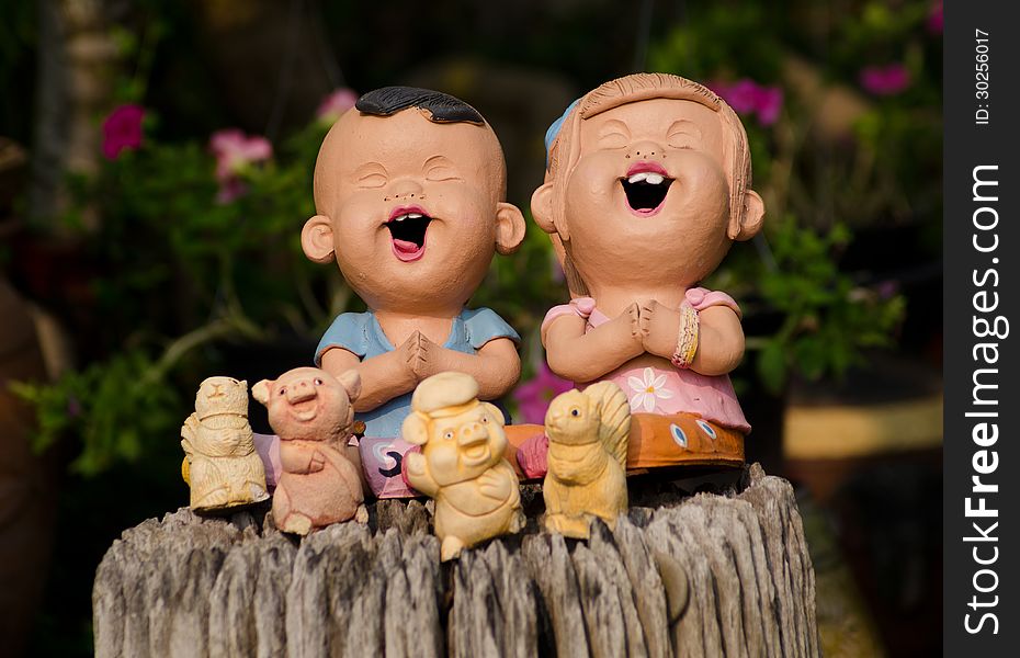 Clay doll boy and girl in garden