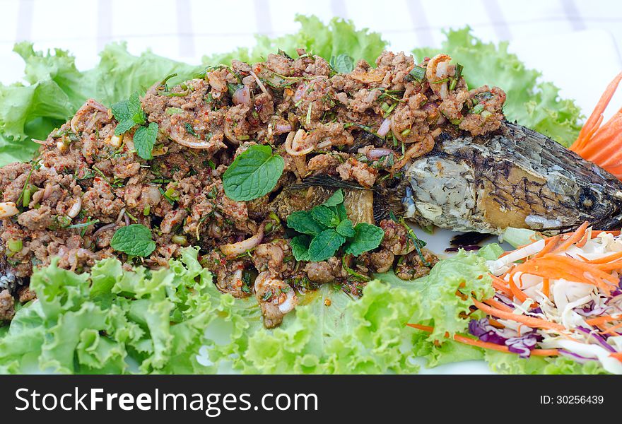 Crispy snake-head fish fried with spicy salad. Crispy snake-head fish fried with spicy salad