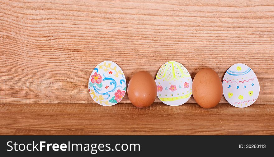 On a wooden background painted eggs for Easter. On a wooden background painted eggs for Easter