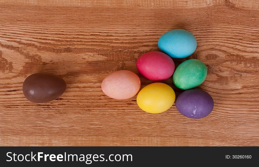 On a wooden background painted eggs for Easter. On a wooden background painted eggs for Easter