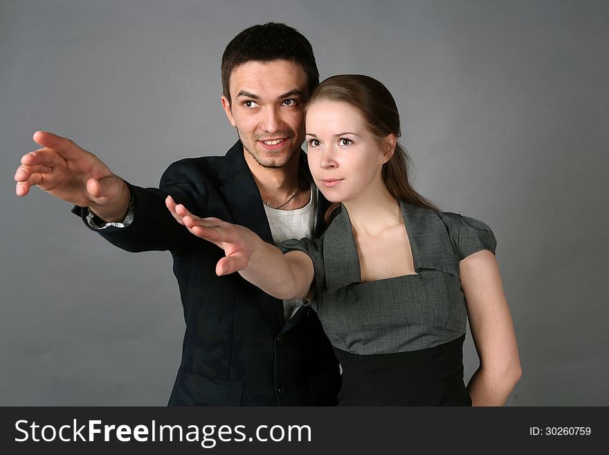 Studio portrait of young couple looking in one direction. Studio portrait of young couple looking in one direction