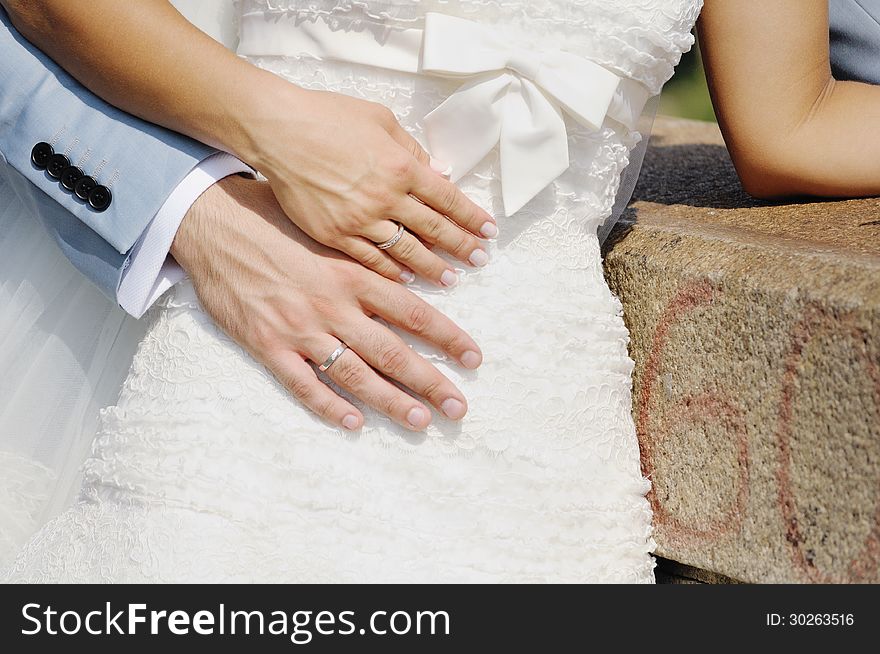 Hands of the bride and the groom with wedding rings. Hands of the bride and the groom with wedding rings