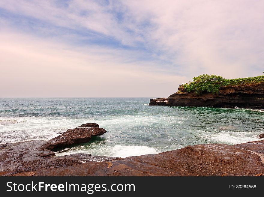 Indonesia Bali island.Tanah Lot in the vicinity, clear sea water,the stone surfaced. Indonesia Bali island.Tanah Lot in the vicinity, clear sea water,the stone surfaced.