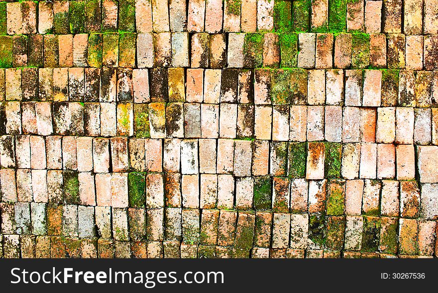 Old Brick wall with moss growing out of it