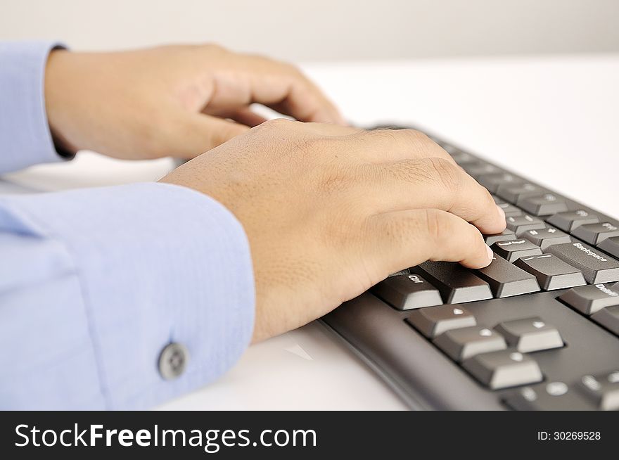 Hands typing on keyboard. This is office environment concept