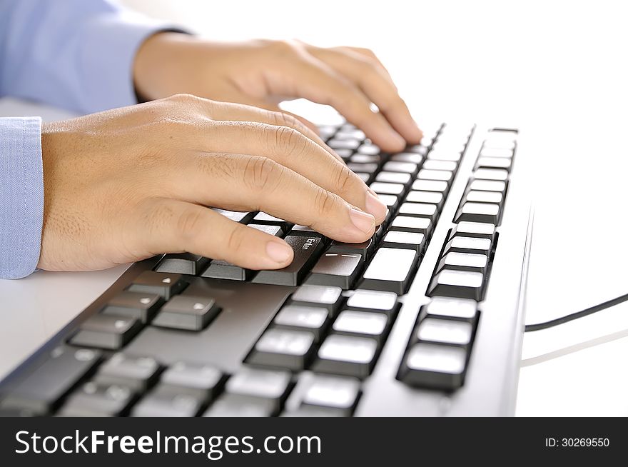 Hands typing on keyboard. This is office environment concept