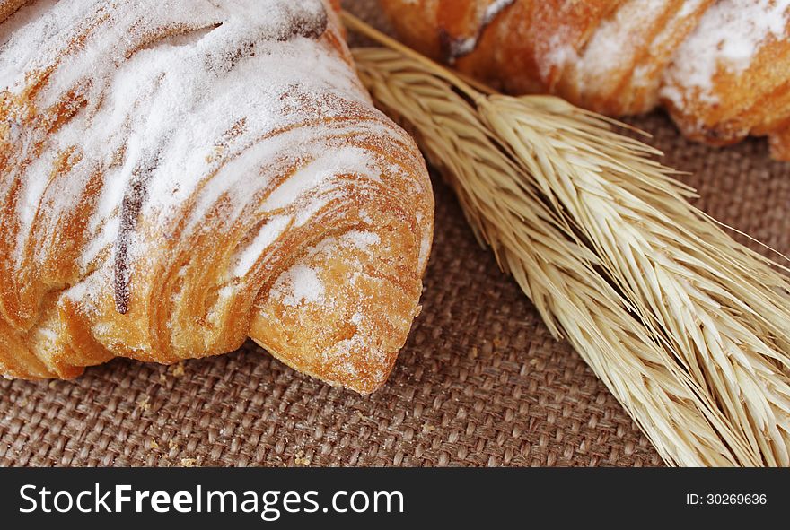 Pasty croissant on the brown background