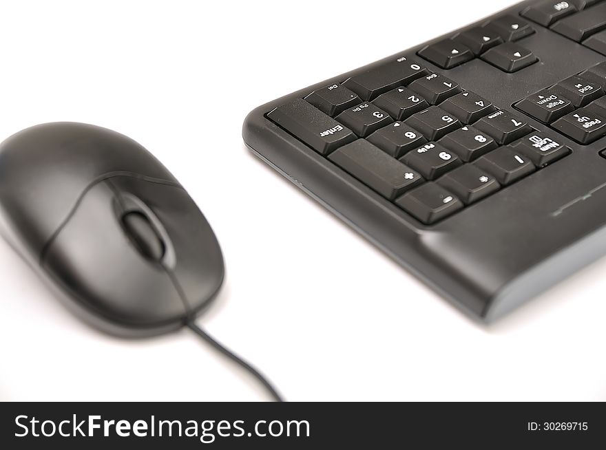 Computer mouse and keyboard on white background