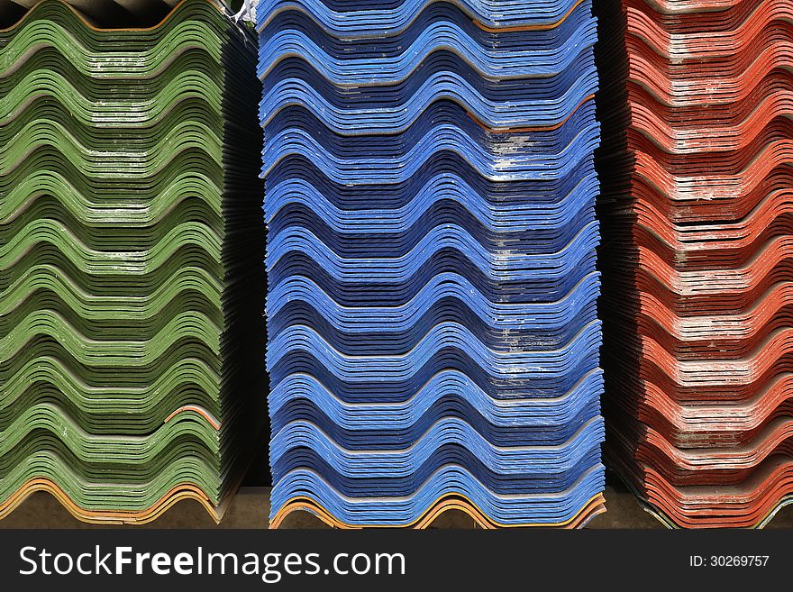 Stack of colorful asbestos roof in warehouse. Stack of colorful asbestos roof in warehouse